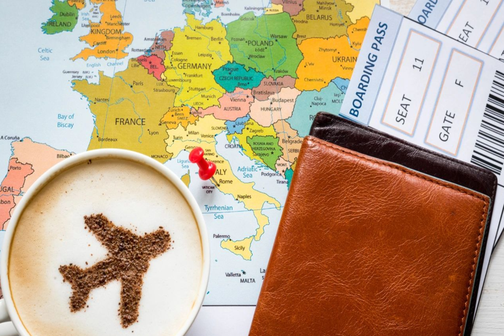 A cup of coffee and a wallet on top of a map